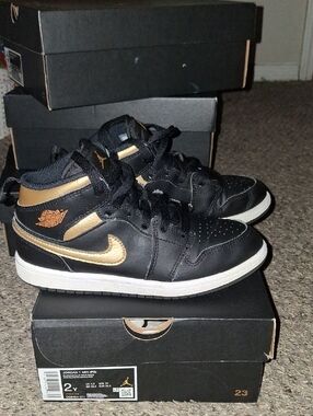 Jordan Black and Gold Mid-Top Sneakers